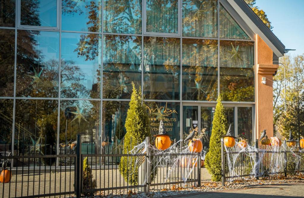 a building with a display of pumpkins in front of it at Hotel Medūna in Druskininkai