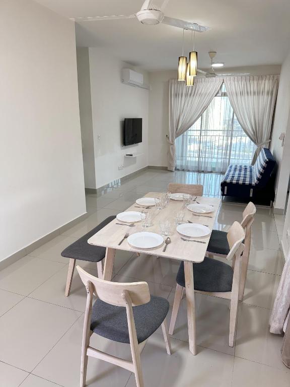 a dining table and chairs in a living room at TuR15 SPlCE 10pax 4room Private House in Bayan Lepas