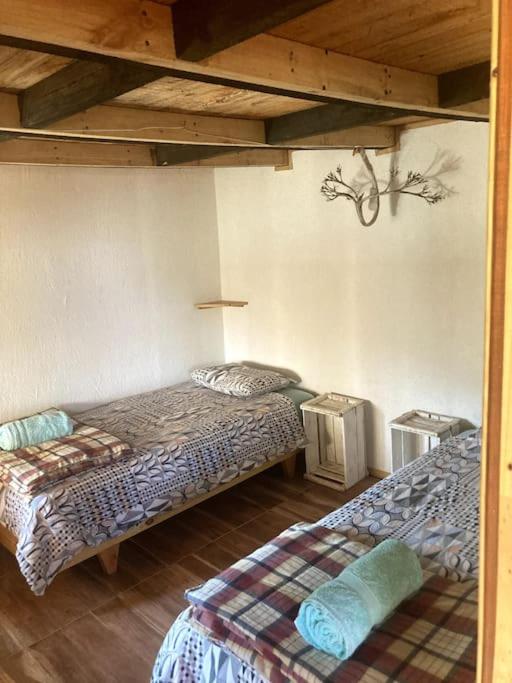 Voodi või voodid majutusasutuse Swiss Eco Lodge La Linda Loma - Olmué toas