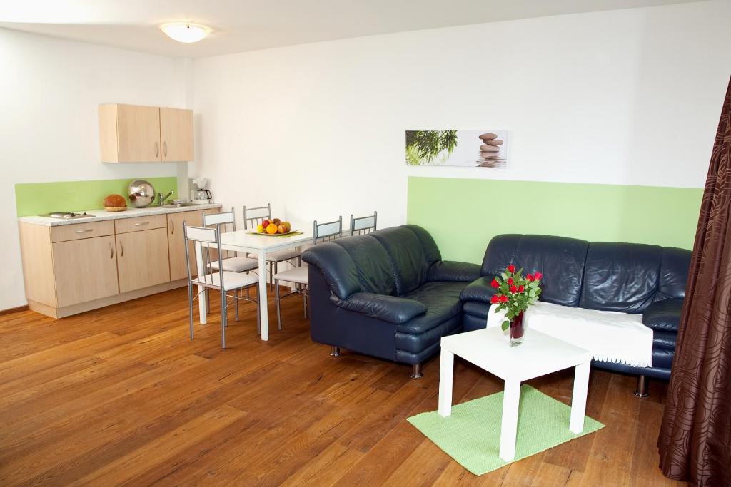 a living room with a couch and a kitchen at Erlachmühle in Mondsee