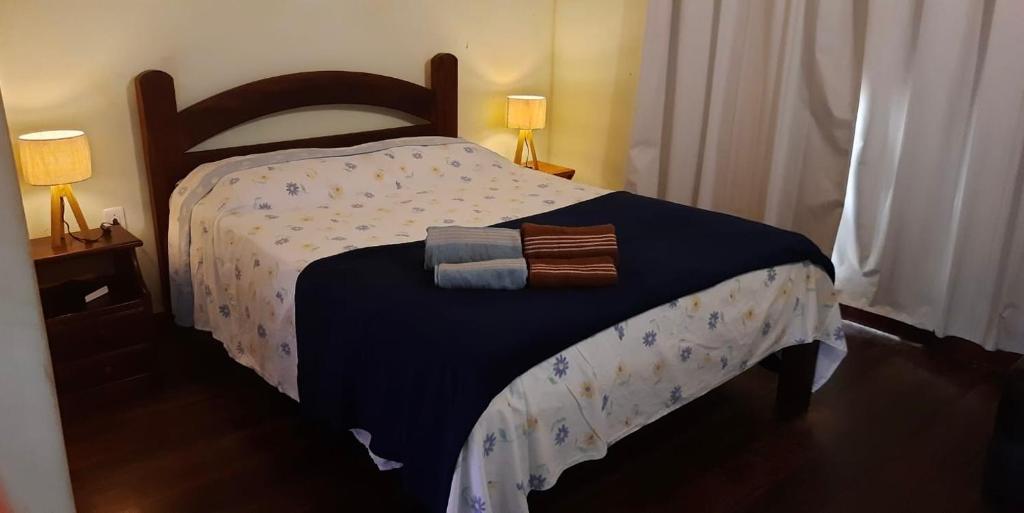 um quarto com uma cama com duas toalhas em Duplex 450m da Praia do Peró com Enxoval, Wi-Fi, TV a Cabo, Estacionamento em Cabo Frio