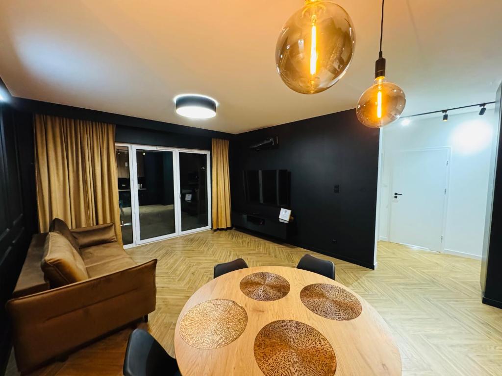 a dining room with a table and a couch at Apartament Plaza Tower 2 in Kielce