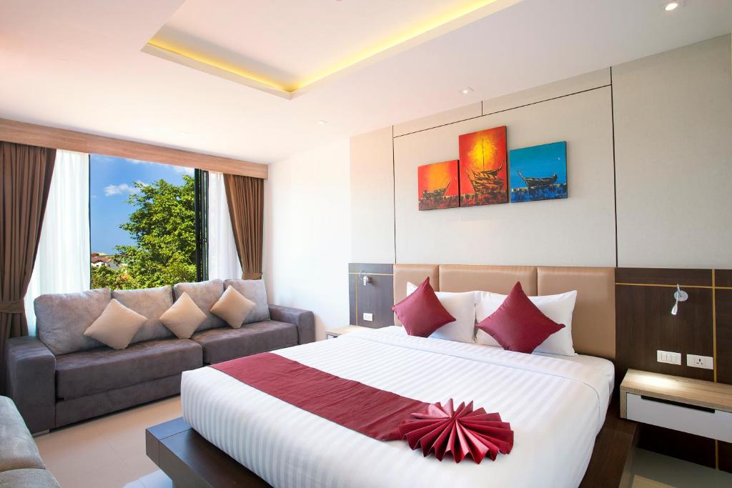 Postel nebo postele na pokoji v ubytování Paripas Patong Resort