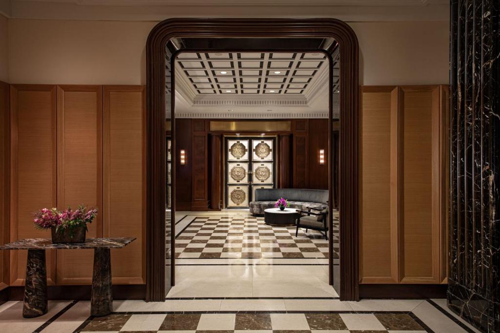 a hallway with a door leading to a living room at JW Marriott Essex House New York in New York