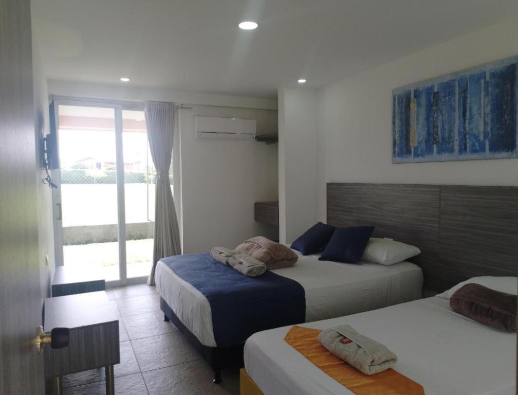 Postel nebo postele na pokoji v ubytování HOTEl PALO GRANDE CF PEREIRA