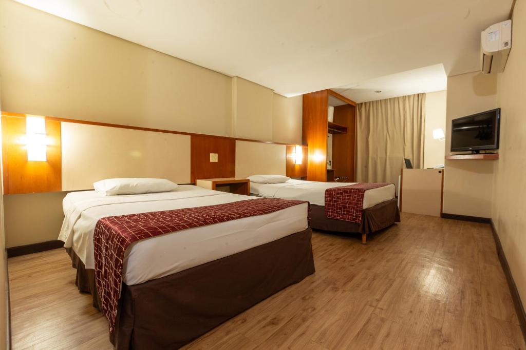 Cama ou camas em um quarto em Rede Andrade CWB