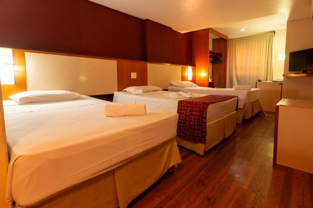 Cama ou camas em um quarto em Rede Andrade CWB