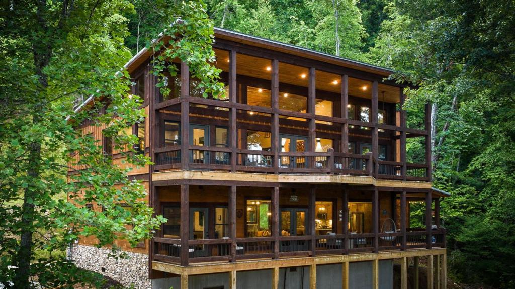 a house in the woods with a lot of windows at Teresa's River Retreat in Blue Ridge