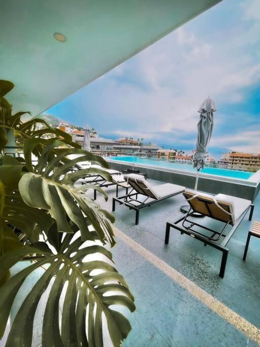 a balcony with chairs and a swimming pool on a building at Loft nuevo en Zona Romántica 203 in Puerto Vallarta