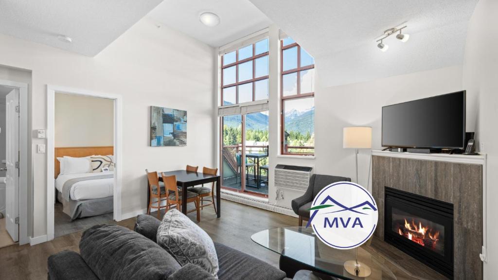 a living room with a couch and a fireplace at Alpenglow Lodge Junior Penthouse by MVA in Whistler