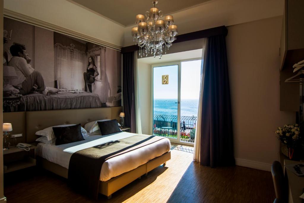 a bedroom with a large bed and a large window at Partenope Relais in Naples