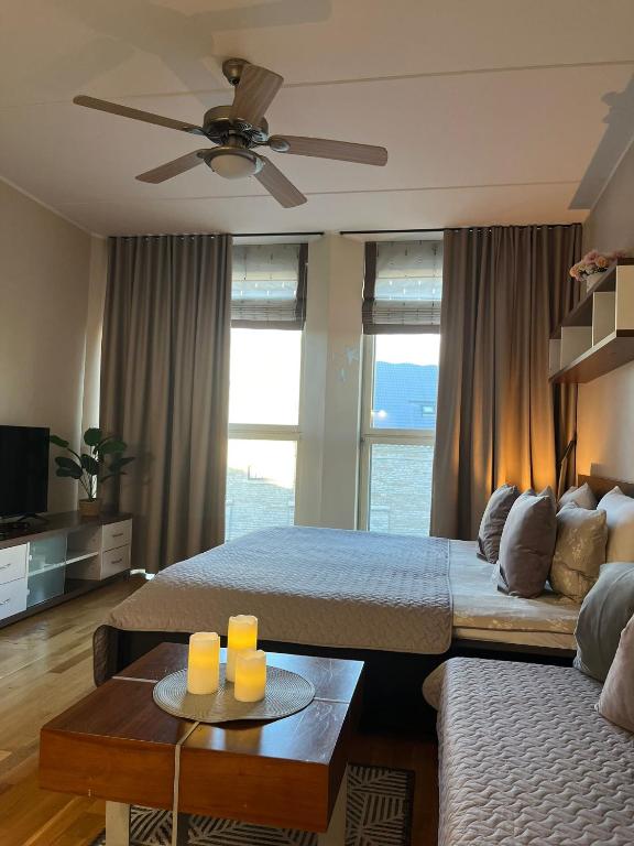 a living room with two beds and a couch at Charming flat next to Old Town and Harbor in Tallinn