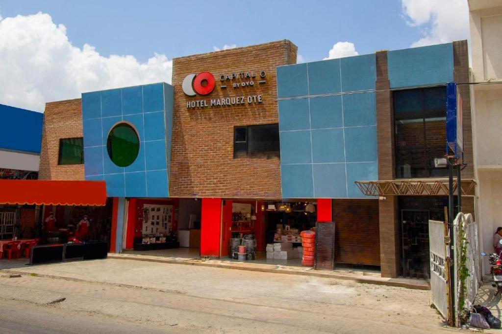ein großes Backsteingebäude mit einem Geschäft auf einer Straße in der Unterkunft Marquez-Ote in San Cristóbal de las Casas