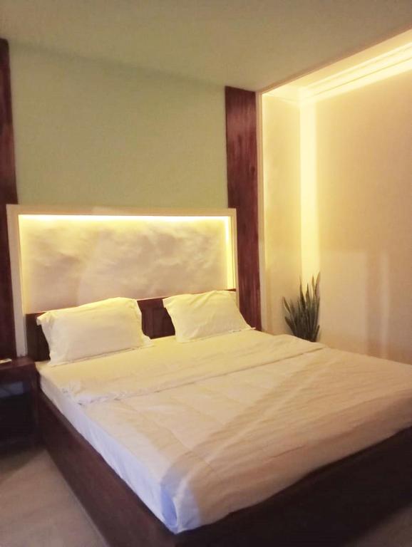 Ένα ή περισσότερα κρεβάτια σε δωμάτιο στο Gratia Homestay