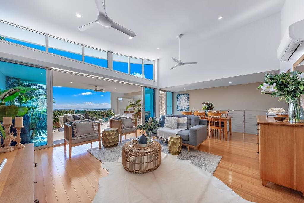 a living room filled with furniture and a dining room at Large, Luxurious Townhouse Stunning Oceanviews in Airlie Beach