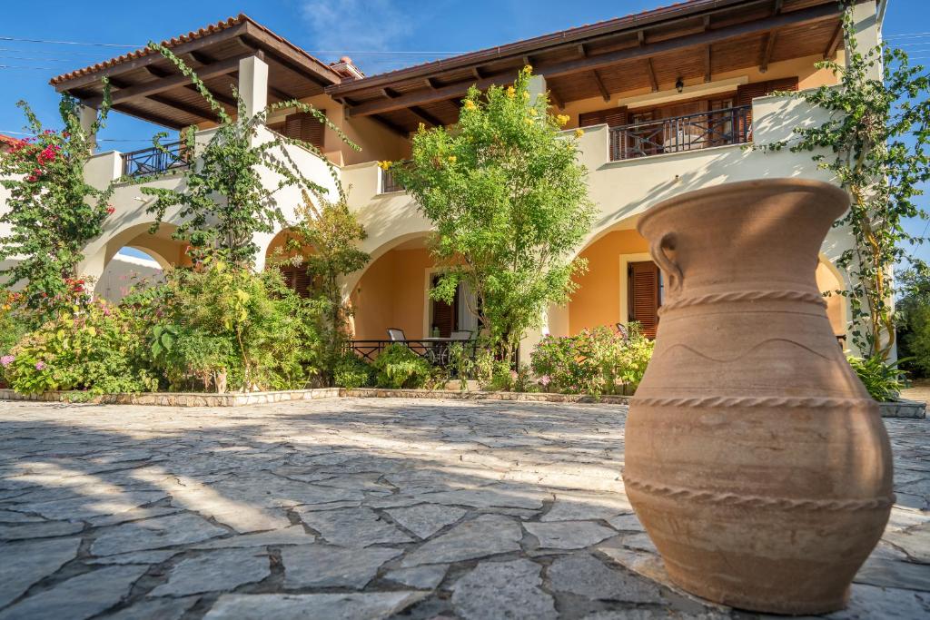 a large vase sitting in front of a building at Olga Studios in Vasilikos