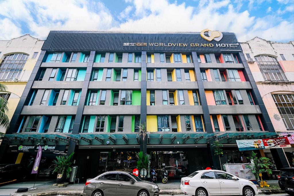 two cars parked in front of a building at Kingston Hotel 2 - Setapak in Kuala Lumpur