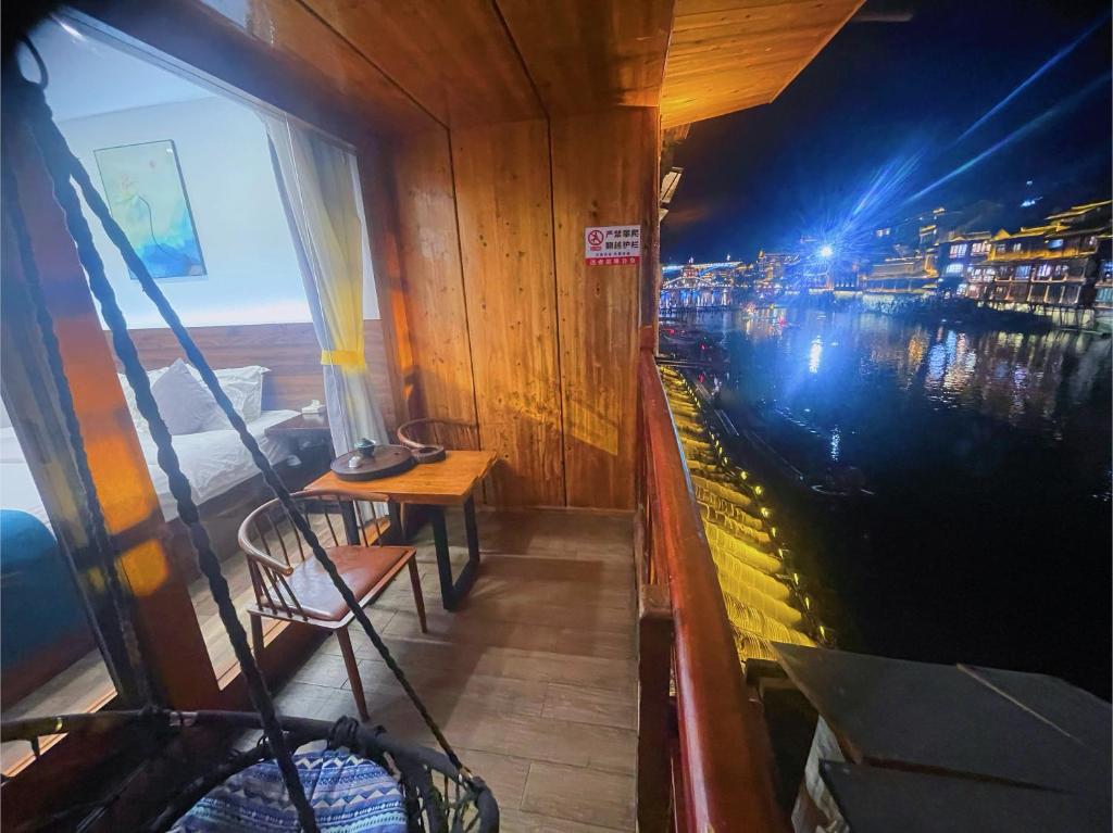 a view from the inside of a boat at night at Bian Cheng Xing Zi Inn in Fenghuang County