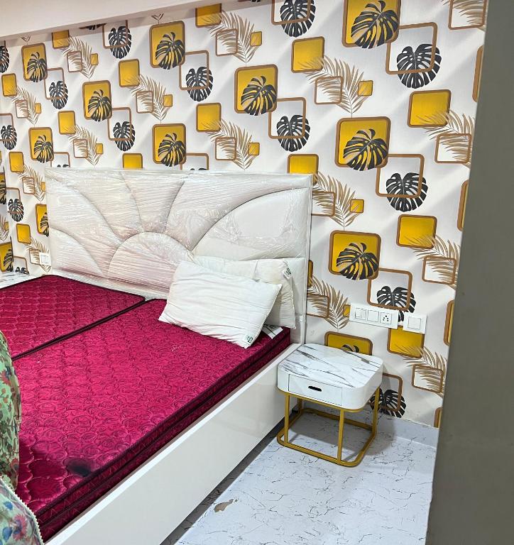 a bedroom with a bed and a wall with a spider pattern at Couple Love Condos 1BHK in Zirakpur