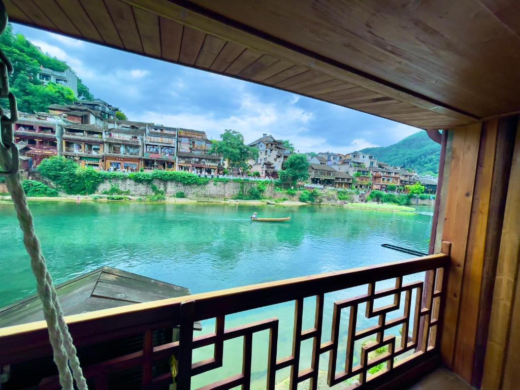 a view of a river from a boat at Bian Cheng Xing Zi Inn in Fenghuang County