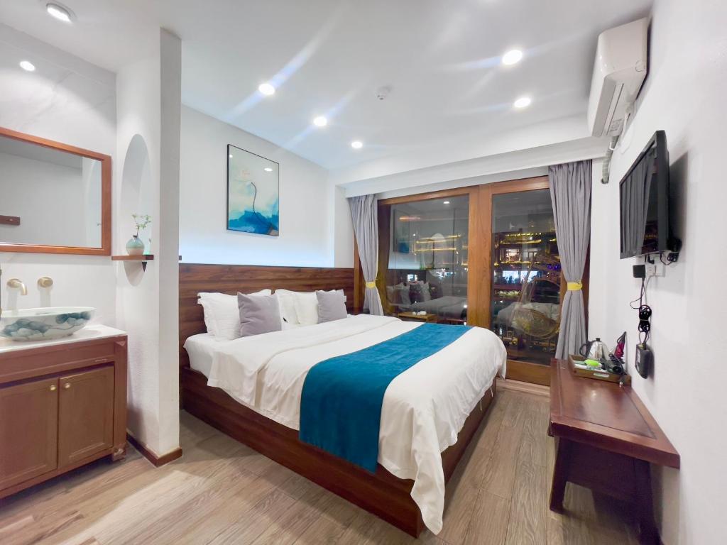 a bedroom with a large bed and a television at Bian Cheng Xing Zi Inn in Fenghuang County