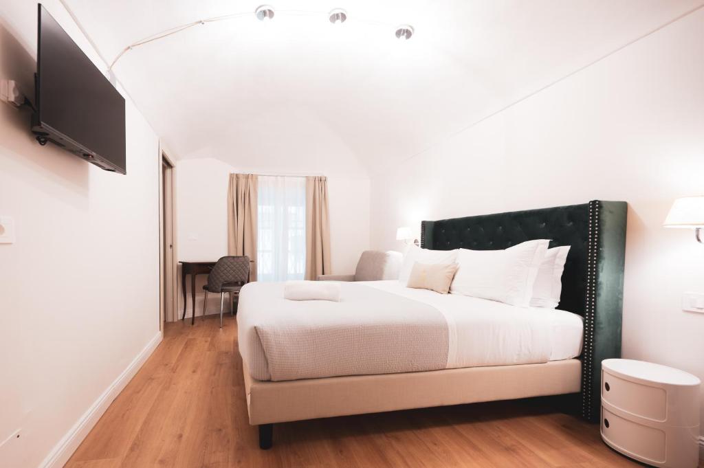 Postel nebo postele na pokoji v ubytování Carlo Felice Boutique Hotel