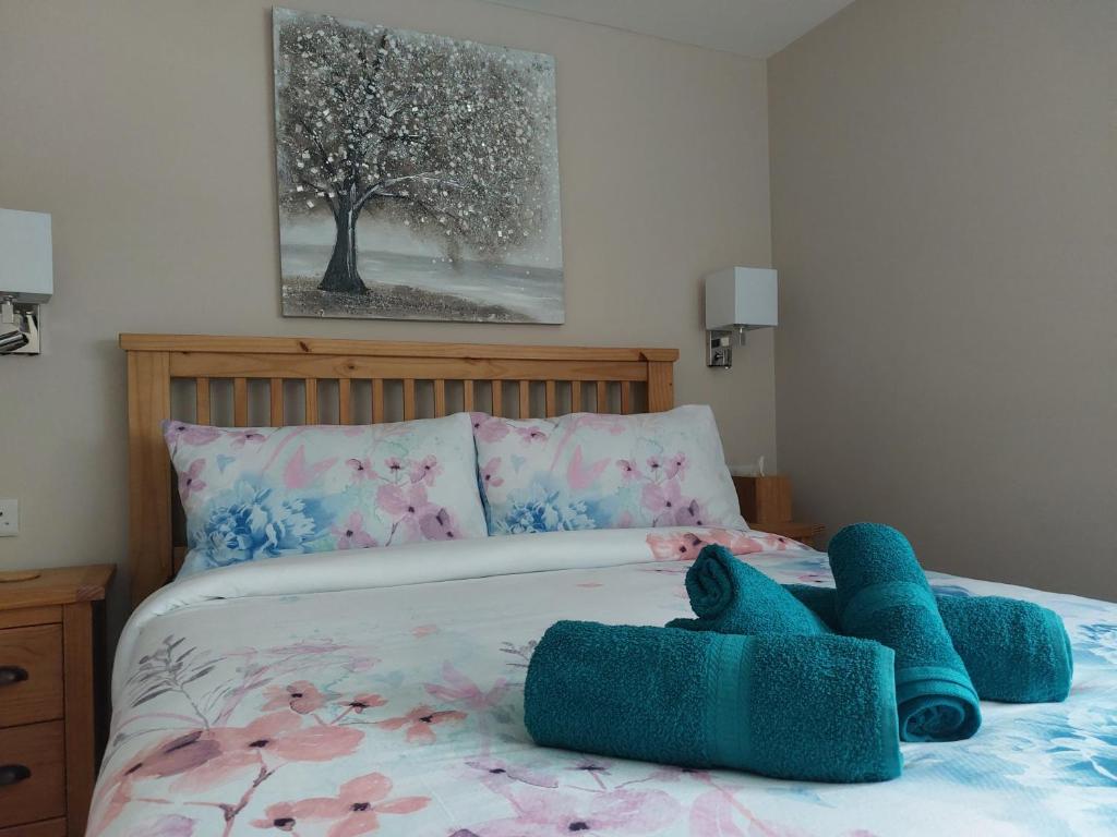 a bedroom with a bed with two stuffed animals on it at Southwell Home Stay in Southwell