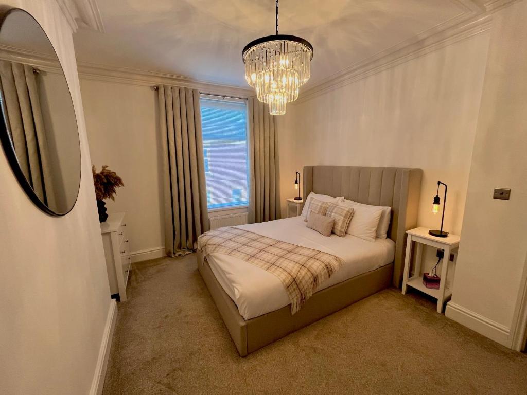 En eller flere senge i et værelse på Coastal Apartments No 2