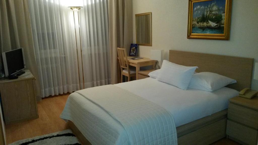 Postel nebo postele na pokoji v ubytování Hotel Century