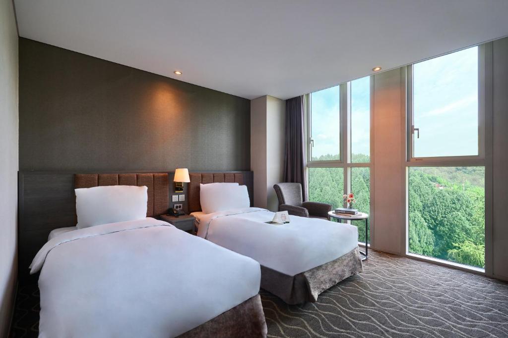 Postel nebo postele na pokoji v ubytování Hotel Square Ansan