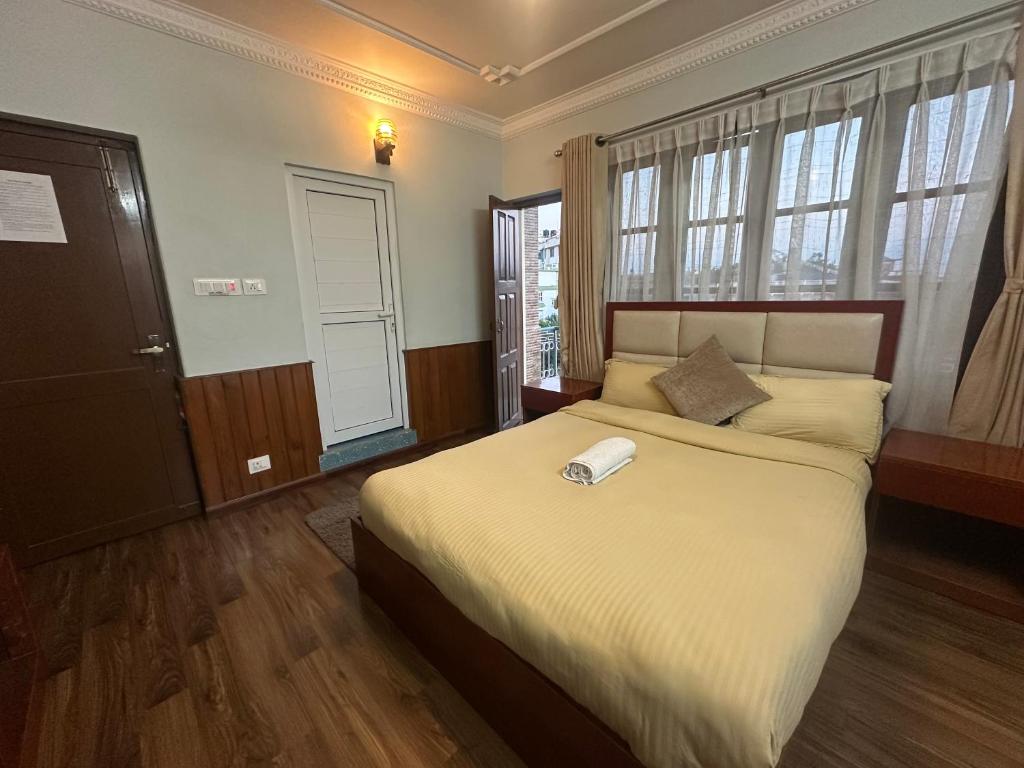Postel nebo postele na pokoji v ubytování Norbu Hotel