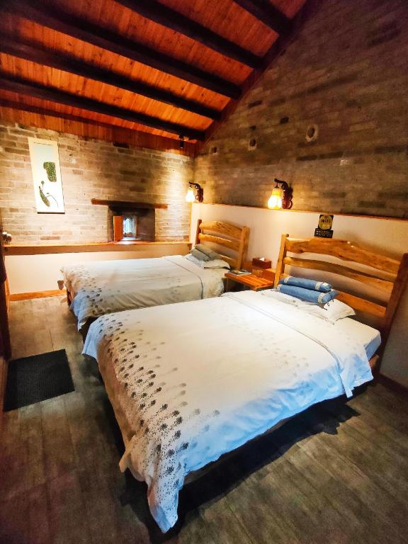 a bedroom with three beds in a room at Governor's Mansion in Yangshuo