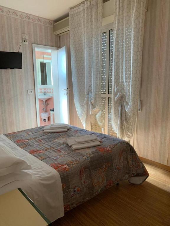 Postel nebo postele na pokoji v ubytování Hotel Villa Edda
