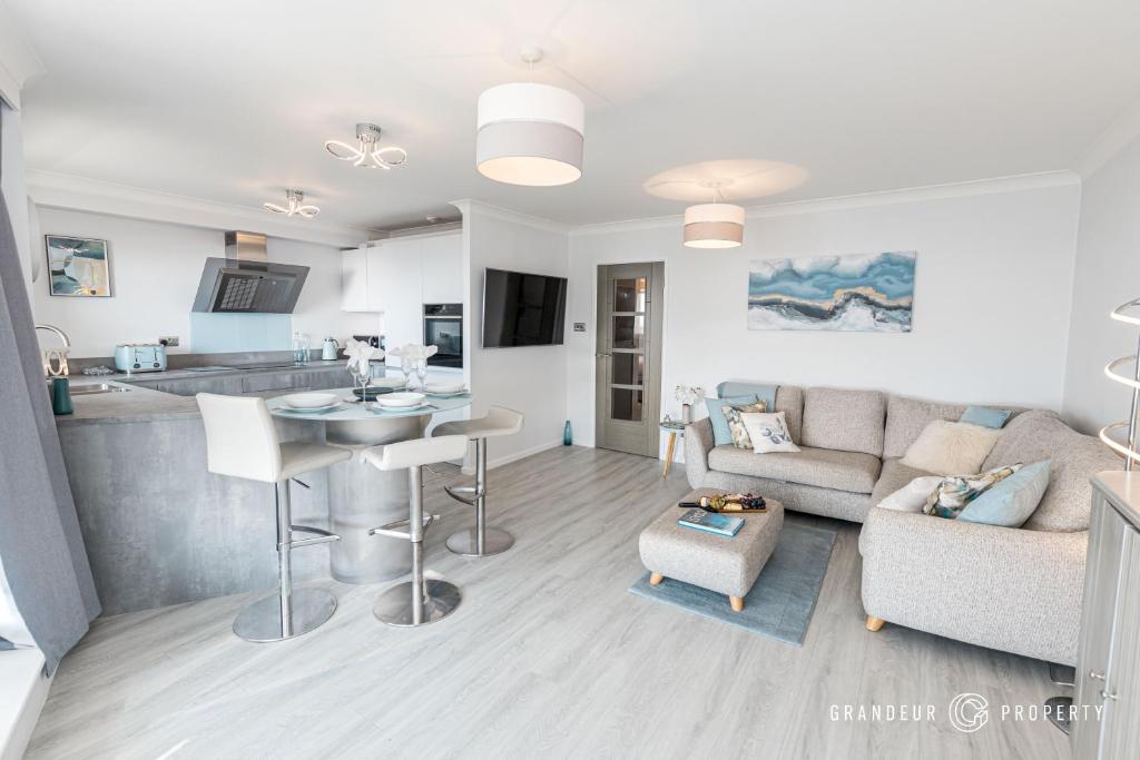 a living room with a couch and a table at Seaview Retreat by Grandeur Property in Southbourne