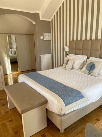 a bedroom with a large bed with a blue blanket at Hotel Metropole in Santa Margherita Ligure