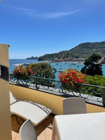 a balcony with tables and chairs and a view of the water at Hotel Metropole in Santa Margherita Ligure