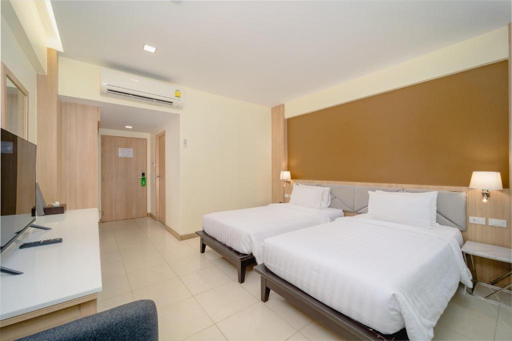 Postel nebo postele na pokoji v ubytování Aonang Buri Resort