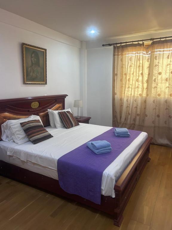 a bedroom with a large bed with two towels on it at Ithaki Phinikoudes Apartments No. 106 in Larnaka