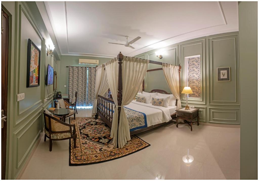 a bedroom with a canopy bed in a room at Luxury Heritage Umaid 3BHK Apartment Jodhpur in Jodhpur