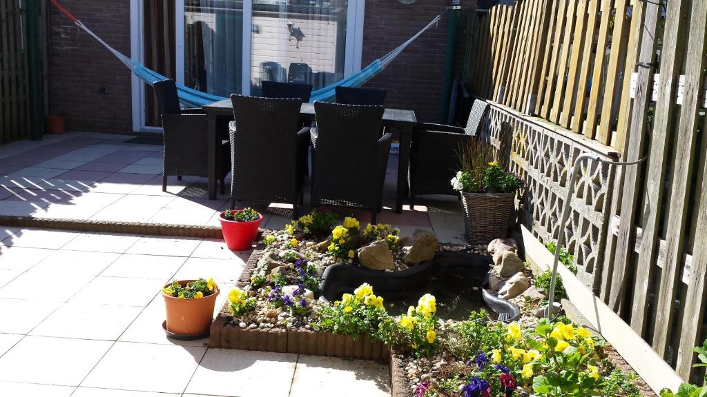 a garden with plants and flowers on a patio at Sewdien's Apartment Beverwaard in Rotterdam