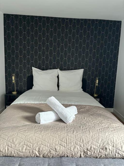 ロングペリエにあるLe Living Roissy CDGのベッド1台(タオル2枚付)