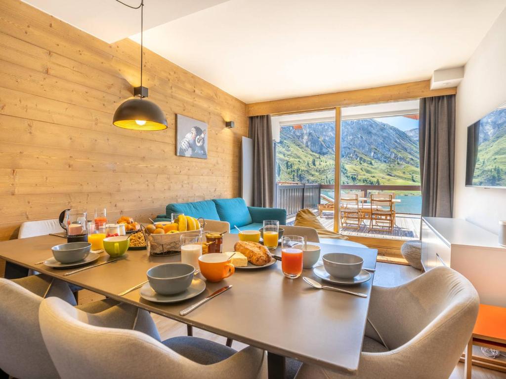 a dining room with a table with food on it at Appartement au centre de Tignes avec terrasse et Wifi - FR-1-641-82 in Tignes