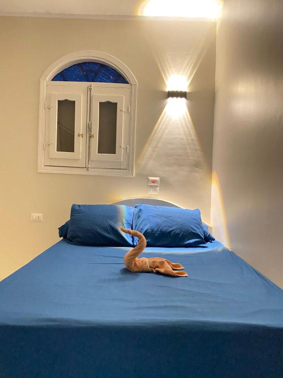 a bedroom with a bed with a fake animal on it at SmSm Kato in Aswan