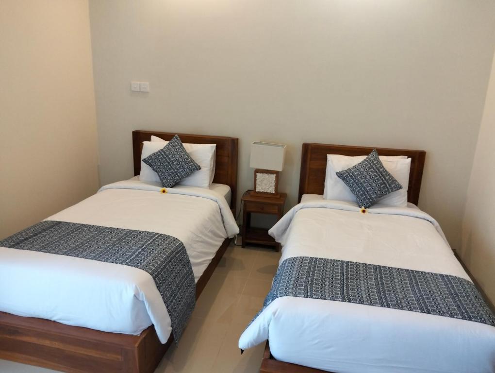 Postel nebo postele na pokoji v ubytování Kutus Bali Guesthouse