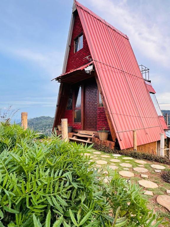 a red roofed house with a red roof at Prince Place Eco Cabana and Camping Site in Passara