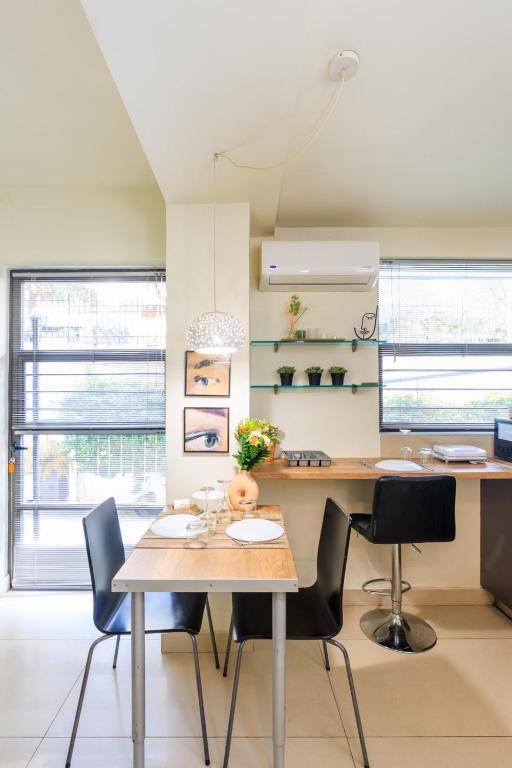 a dining room with a table and chairs at AIOLOS glyfada centre apartment 1 in Athens