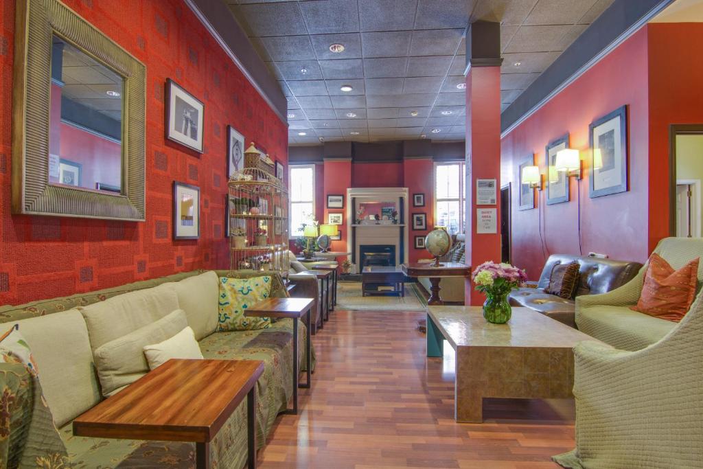 a lobby with couches and tables in a room at Adelaide Hostel in San Francisco