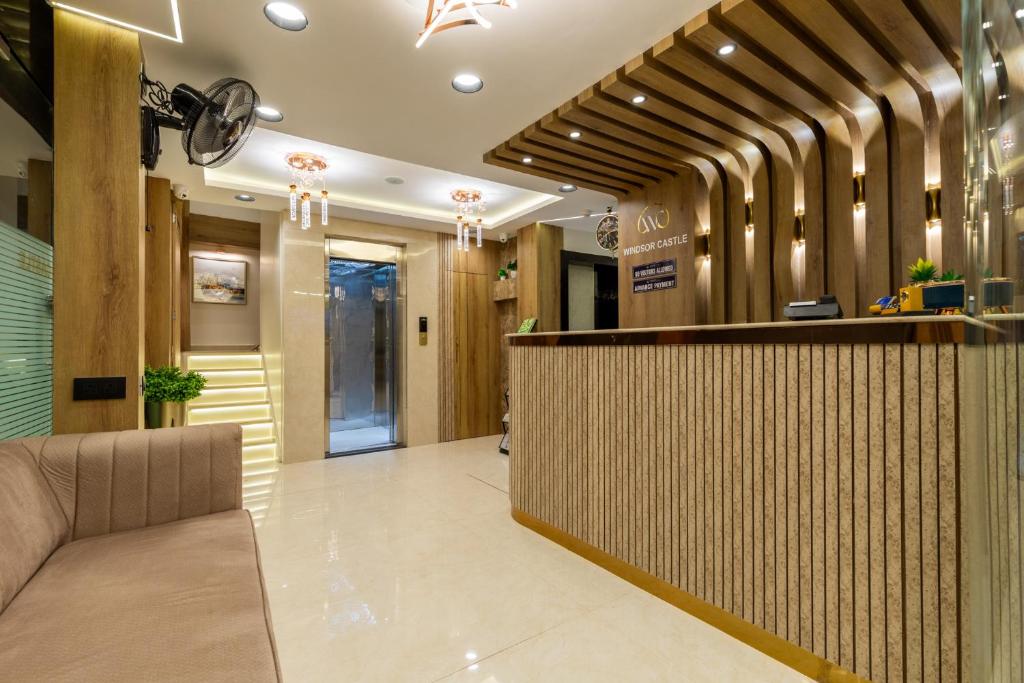 a hotel lobby with a reception desk and a lobby at Hotel Windsor Castle in Mumbai