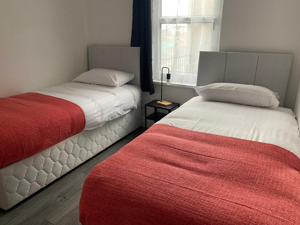 two beds sitting next to each other in a bedroom at Twin Room - Botanic, Belfast in Belfast