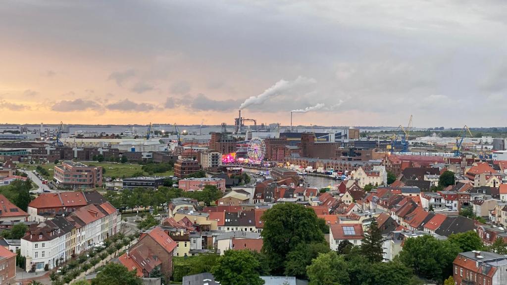 a cityscape of a city with a factory at YourHomeWismar in Wismar